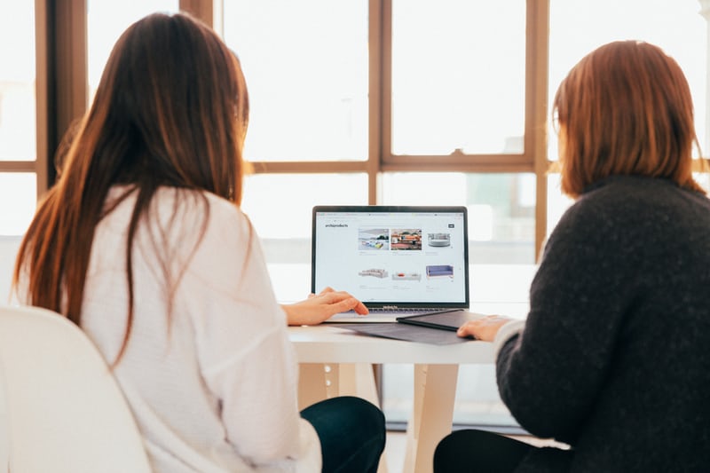 two people looking at a computer