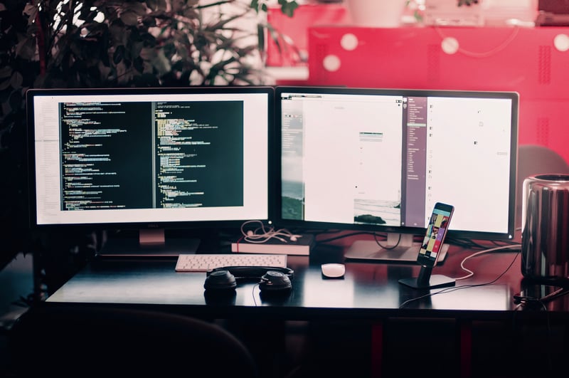 Two computer monitors showing data
