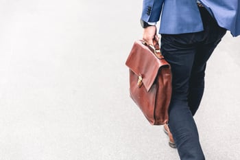 investment salesperson walking with a briefcase